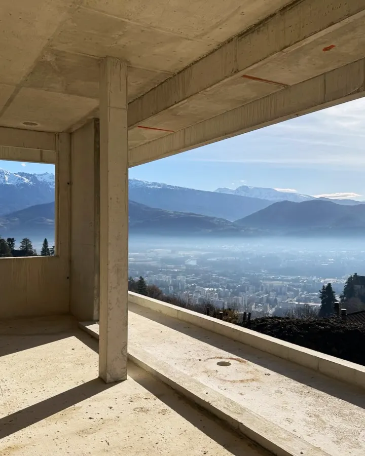 Construction d'une maison en béton avec vue panoramique sur les Alpes
